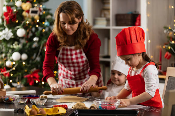 istock Woman rolling out the gingerbread cookie dough 1334609899