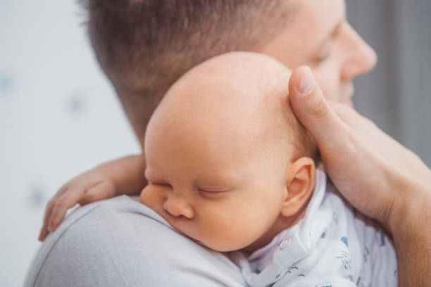 istock Father holding baby son 1334610275