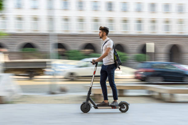 istock Young student bypassing traffic with electric scooter 1334611452