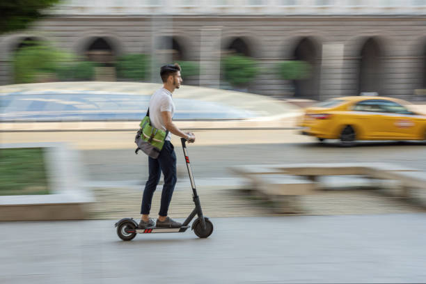 istock Young student bypassing traffic with electric scooter 1334611466