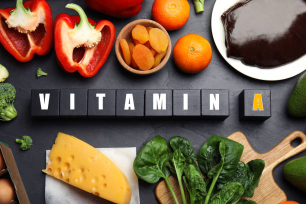 istock Cubes with phrase VITAMIN A and fresh products on black table, flat lay 1334611522