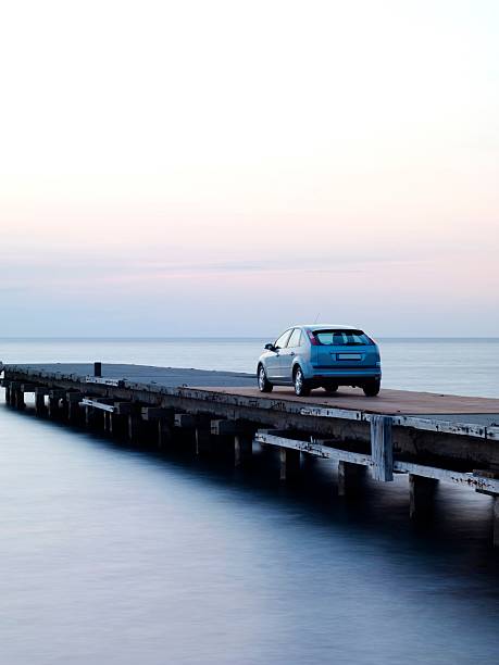 Car parked in the pier at sunset