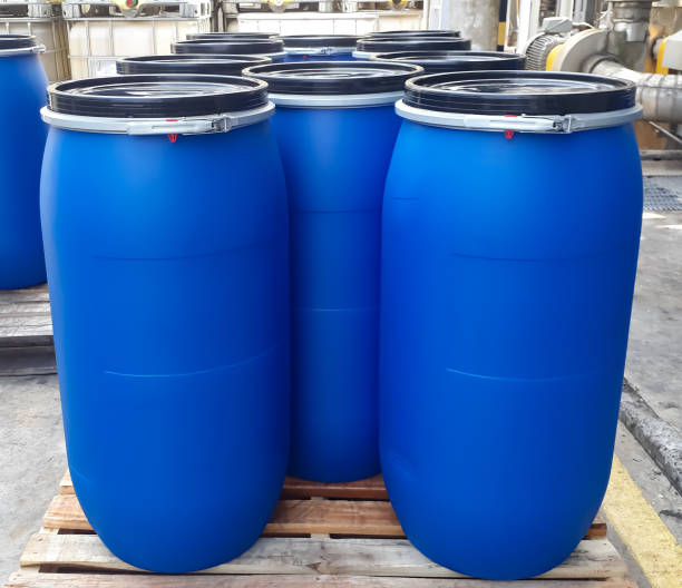 istock Blue plastic drums on wooden pallet 1334612969