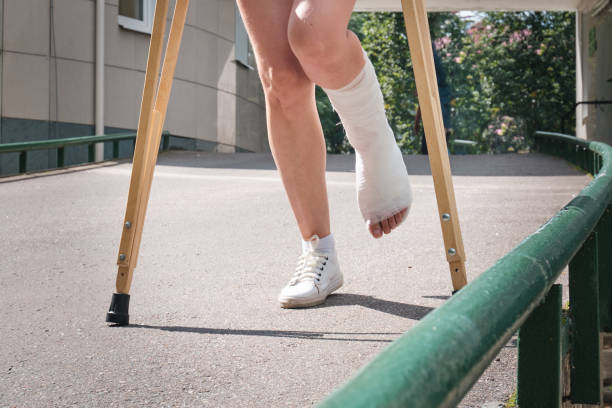 istock A woman with a broken leg walks down a ramp using orthopedic crutches 1334613974