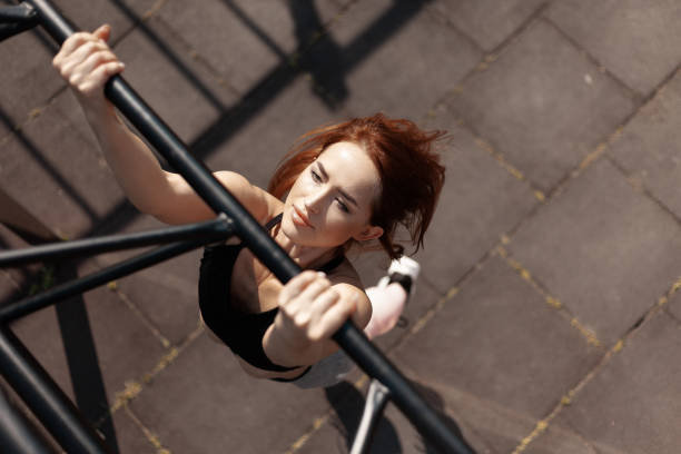istock The athlete pulls herself up on the bar. Strong beautiful athletic woman 1334615595