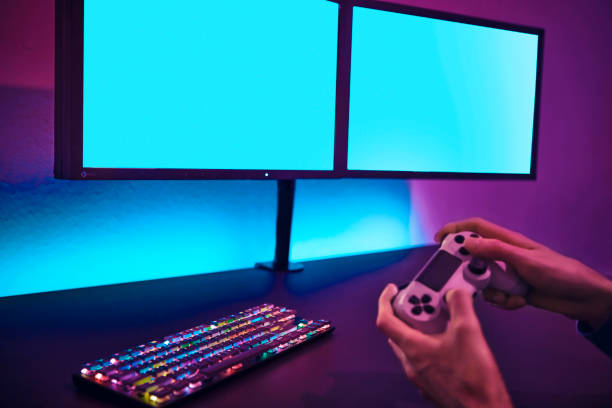 istock Male player using computer keyboard and mouse. Blank monitor to insert your content. 1334622514