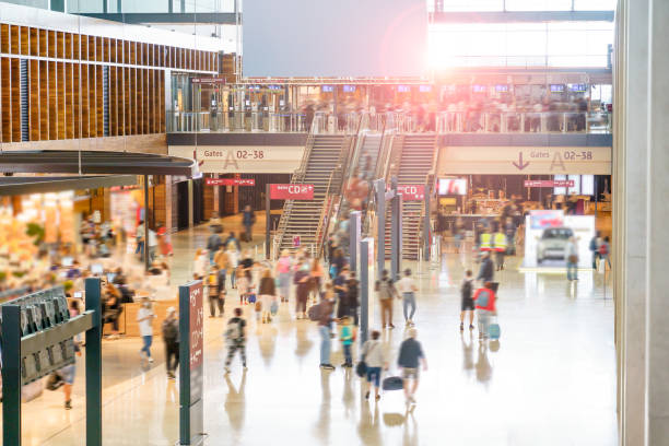 Airport Hall with Travelers Main airport hall with duty free shops, restaurants and VIP lounges. There is a large group of travelers going to their departure gates to catch flights for business and vacation. duty free stock pictures, royalty-free photos & images