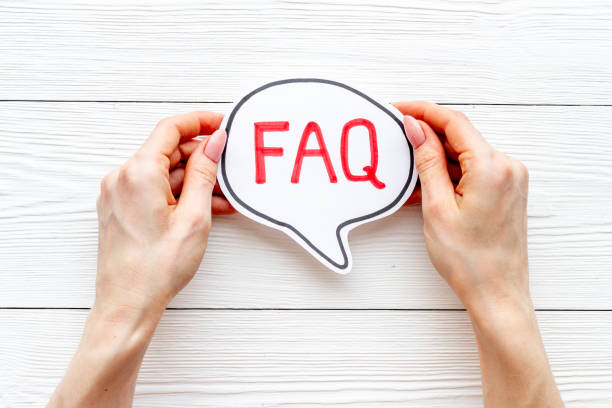 istock Hands with faq word on paper bubble. Frequently asked questions concept 1334622950
