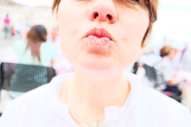 Young caucasian woman sending kiss with passion. White colours, outdoor, lifestyle, happy Young caucasian woman sending kiss with passion. White colours, outdoor, lifestyle, happy kissing on the mouth stock pictures, royalty-free photos & images