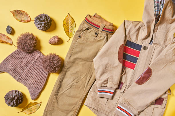 istock Kid autumn wear clothes on yellow 1334623234