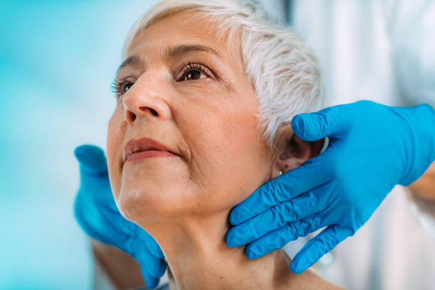 istock Endocrinologist Examining Senior Woman with Thyroid Gland Problems at a Clinic. 1334623977