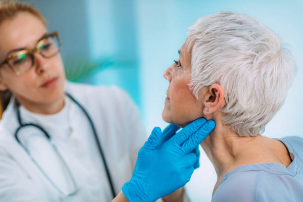 istock Endocrinologist Examining Senior Woman with Thyroid Gland Problems at a Clinic. 1334624334