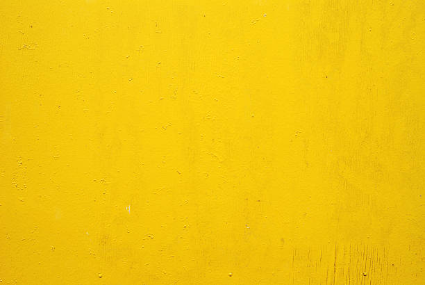 Flat yellow wall with small markings stock photo