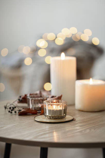 istock Cozy home composition with candles on blurred bokeh background. 1334626471