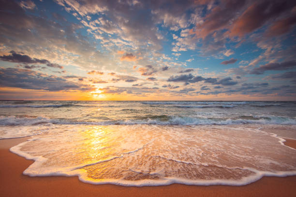 istock Beautiful cloudscape over the beach and sea at sunrise 1334627717