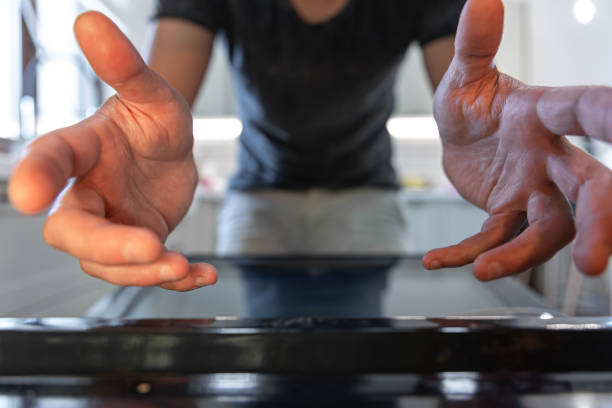 istock Male hands reach for the open oven to get something. 1334627834