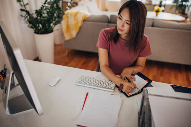 istock Japanese woman working in home office 1334628021