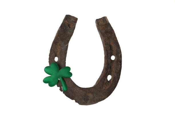 istock Old horseshoe and clover on white background. St. Patrick's Day celebration 1334629416