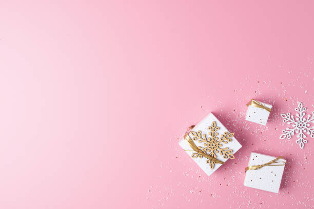 istock Christmas decorations with gifts on pink background. Flat lay, copy space 1334631061