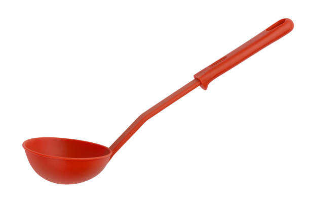 istock Red plastic ladle with a long handle on a white background 1334631327