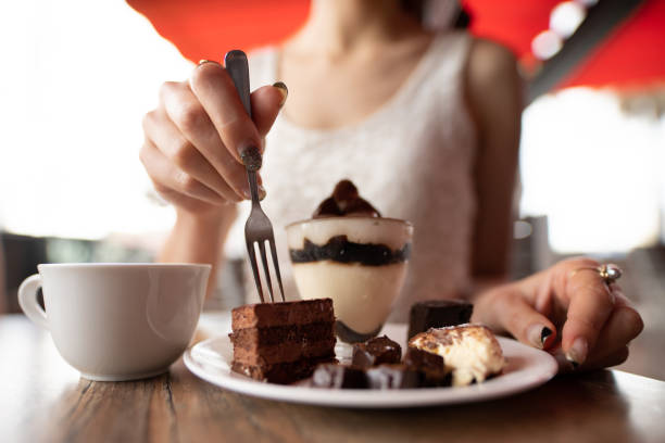 istock Woman eating sweets at a cafe 1334632411
