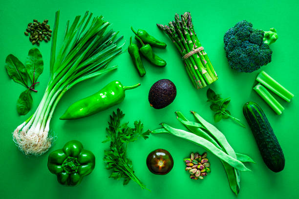 istock Overhead view of green vegetables on green background 1334636841