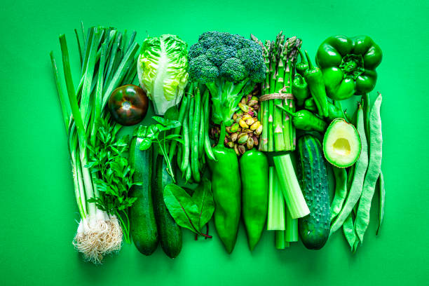 istock Healthy food: green vegetables on green background 1334636843