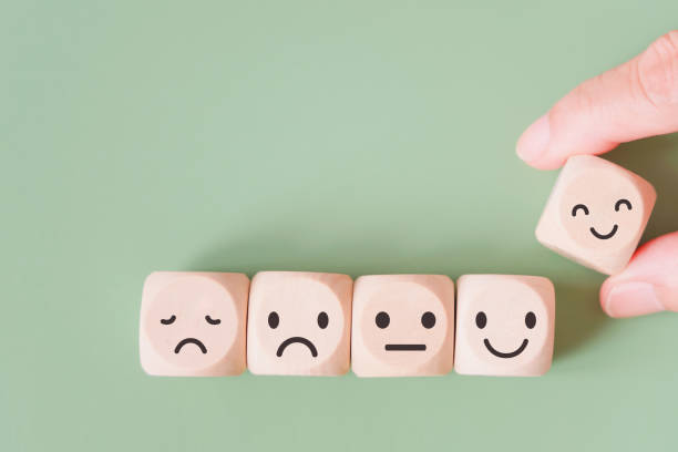 istock hand selected happy face wood cube and others on green background for customer service evaluation, feedback, satisfaction survey or mental heath concept 1334637465