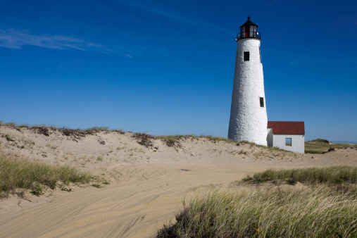 Great Point Lighthouse on Nantucket and the sandy road that leads to it.