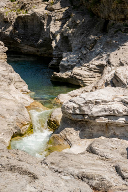 istock Quiet turquoise river stream along the tectonic rocks 1334640070