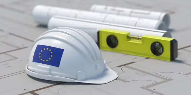 Construction industry in EU. European Union flag Architect engineer hardhat white color on residential building project blueprint plans, 3d illustration