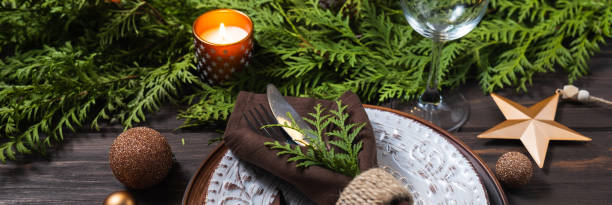 istock Festive table setting with winter decor. Christmas or New Year holiday banner. 1334640376
