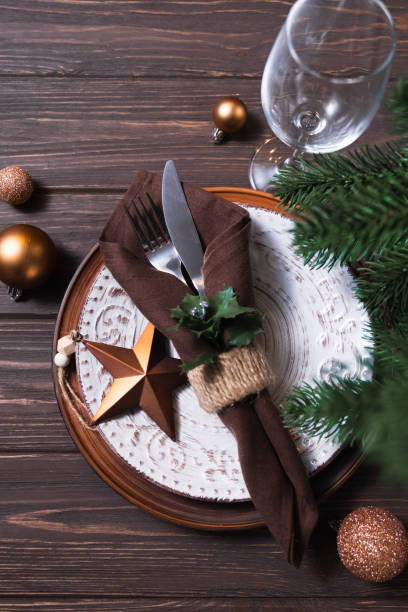 istock Christmas table setting with winter decor on wooden background. 1334640469
