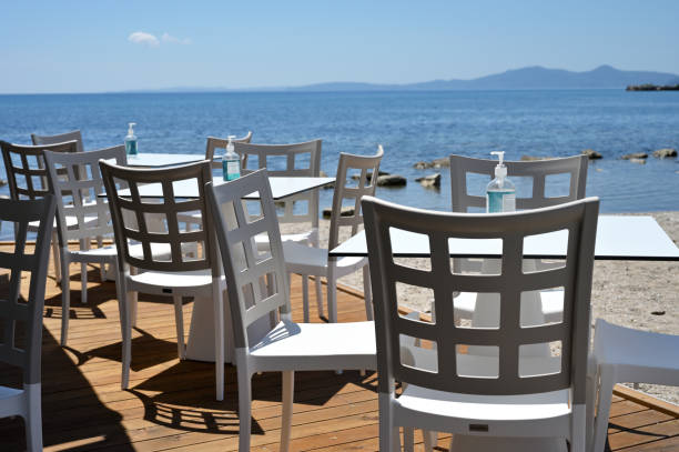 istock Empty restaurant on seashore, sanitizer bottles on tables 1334641707
