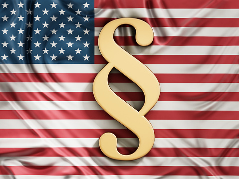 Golden paragraph symbol  standing on American flag.