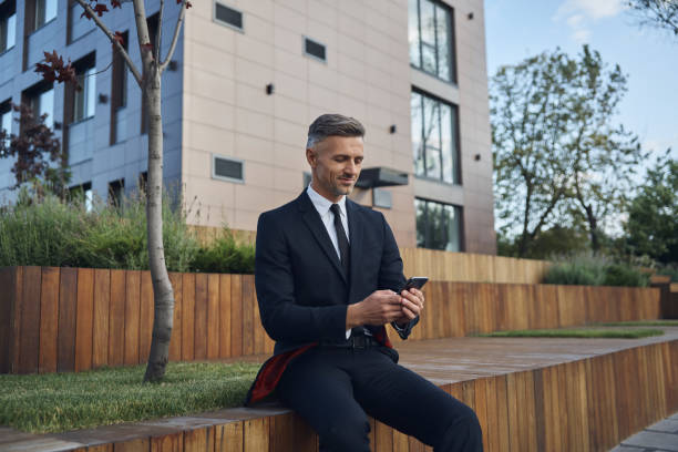 istock Confident mature businessman using smart phone 1334643539
