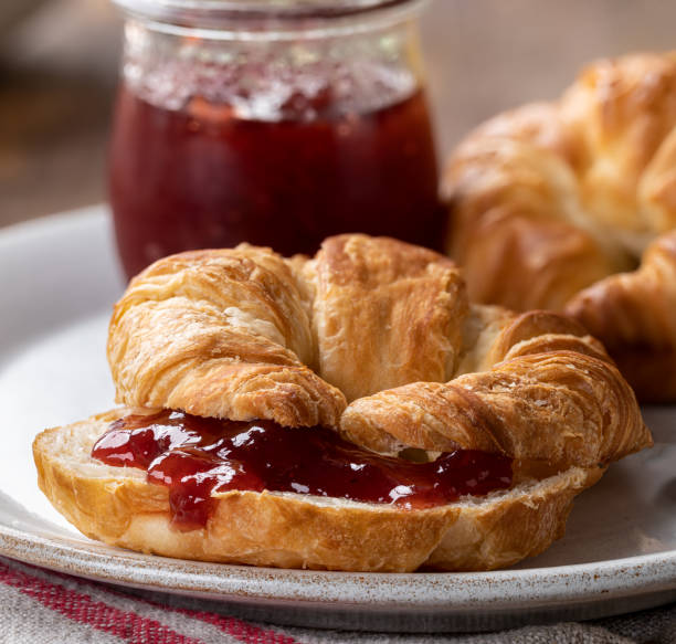 istock Croissant spread with strawberry preserves 1334644110