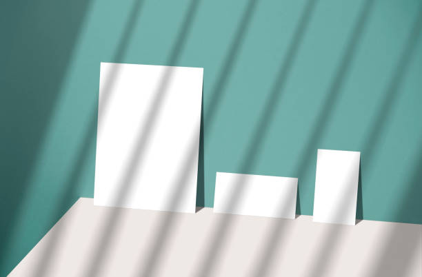 istock Blank paper sheet card with copy space and sunlight shadow on blue background. for mock-up creative design template. 1334644843