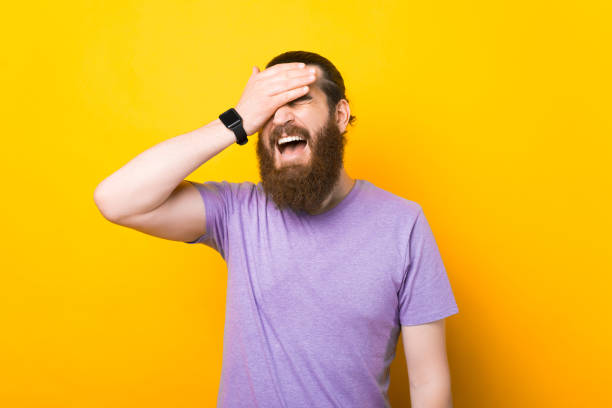 istock Bearded man is making a face palm in a studio over yellow background. 1334645059