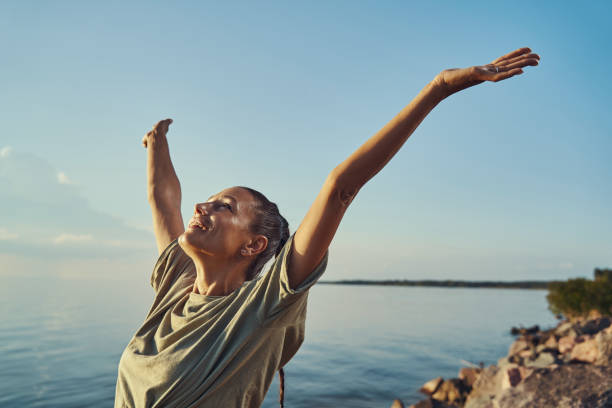 istock Woman raising hands up and feeling free 1334645474