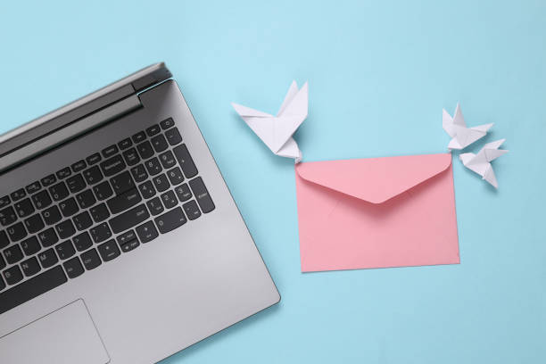 istock Notebook and origami doves with envelope on blue background. Email 1334645494