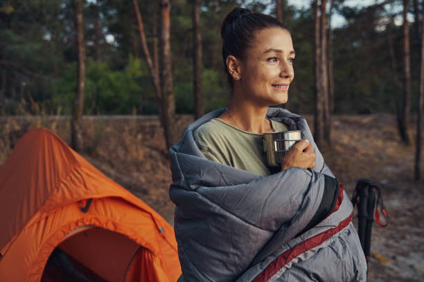 istock Camper wrapped in grey cover and holding tea 1334645594