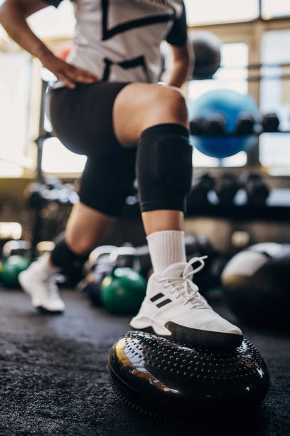 istock Young woman exercising in gym 1334650854
