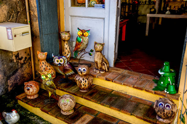 Figurines in doorway Various figurines in the doorway of a shop in the hill town of Biot, France on the French Riveria. biot stock pictures, royalty-free photos & images