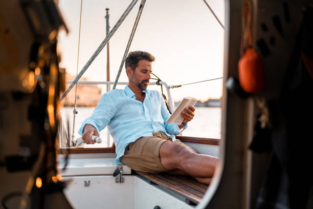 istock Reading a book on the sailboat 1334651974