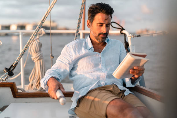 istock Reading a book on the sailboat 1334651975