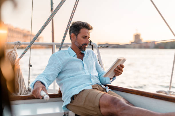 istock Reading a book on the sailboat 1334651976