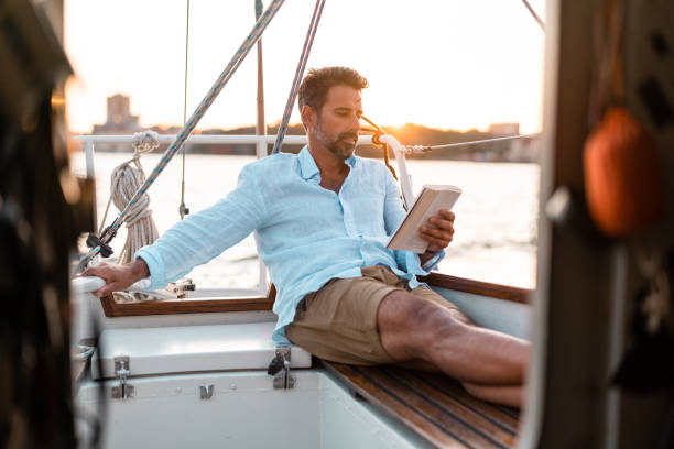 istock Reading a book on the sailboat 1334651979