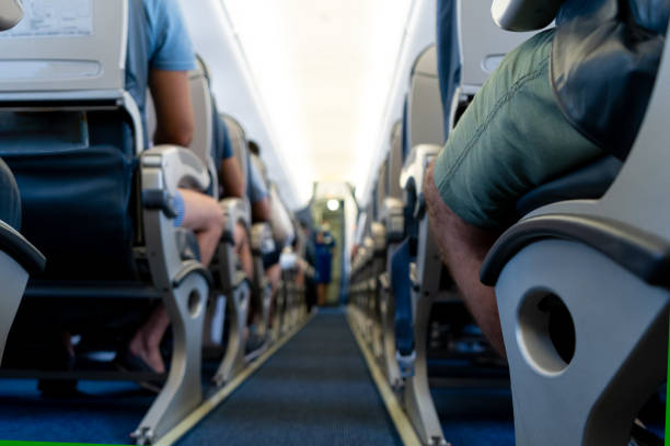 Airplane background selective focus. Blur. The passage between the seats inside the aircraft cabin. Passengers are ready to fly stock photo