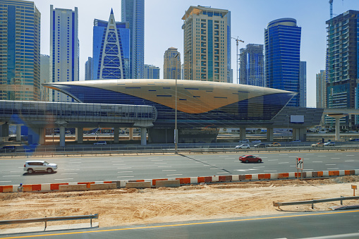 Al Garhoud district, Dubai: Dubai International Airport, terminal 3 with its teardrop windows - Emirates aircraft at a gate position (A6-EGG - Boeing 777-31H ER) . Futuristic glass and steel façade, the terminal was designed by Aéroports de Paris (ADPi) as the hub for Emirates.